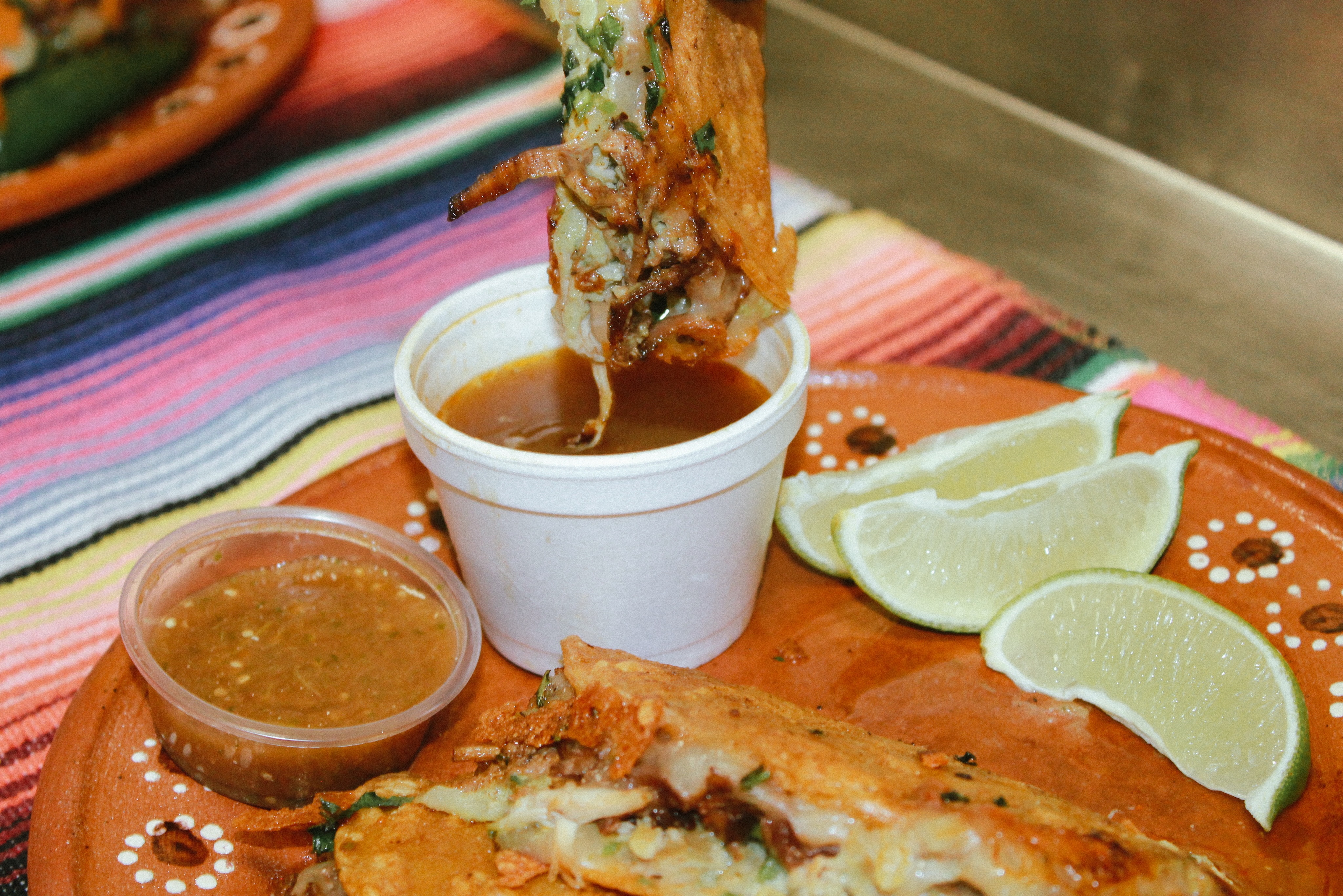 Quesabirria with a rich consommé dip